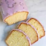 citroencake met lavendel glazuur met daarvoor drie plakjes van deze cake